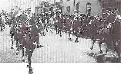 Queen Street, 1911. Horsemen lead the procession celebrating the Coronation of King George V.